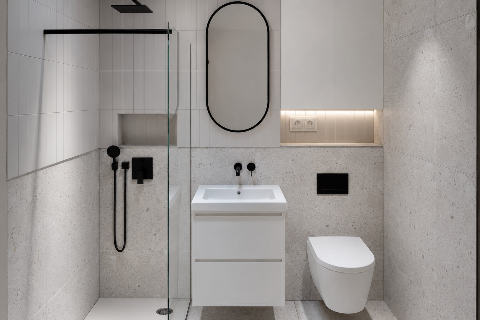 Small bathroom with shower, white vanity and rounded mirror